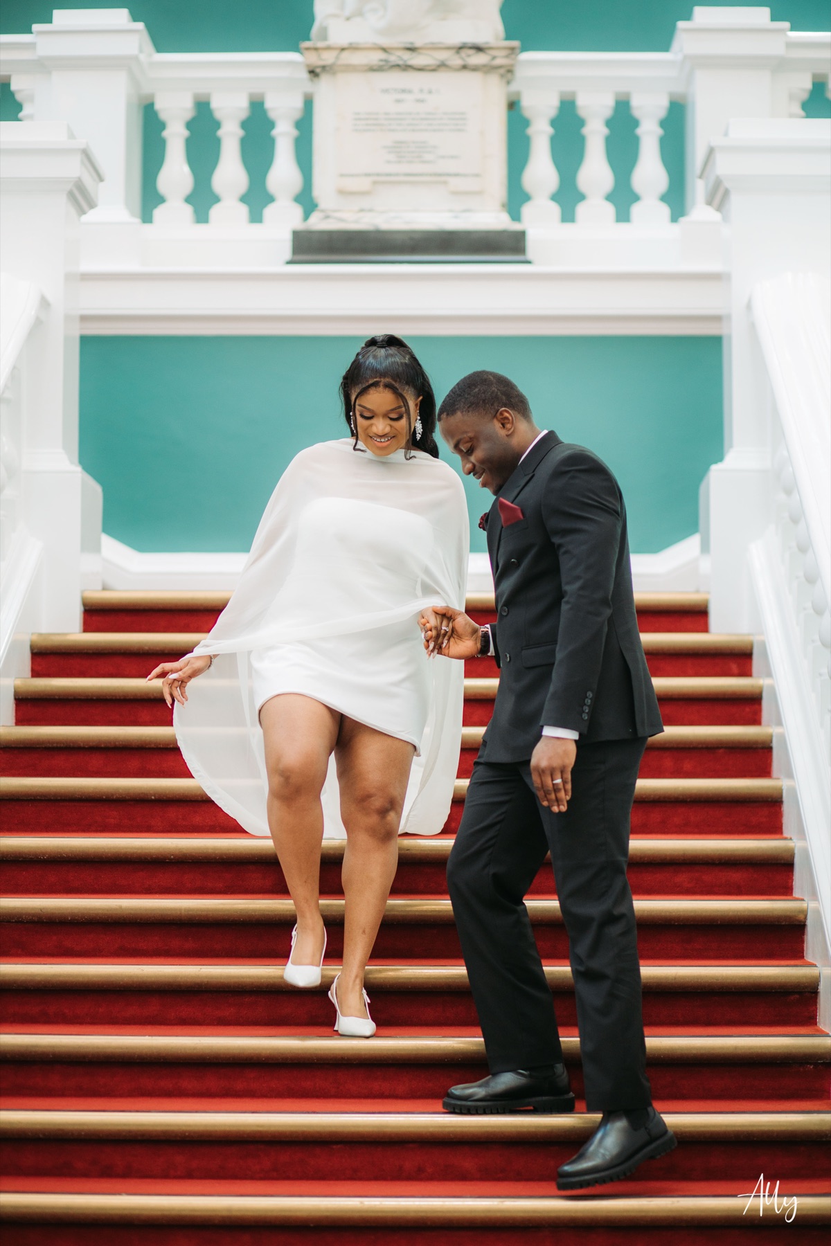 Mercy and Ifeoluwa celebrating together on the staircase