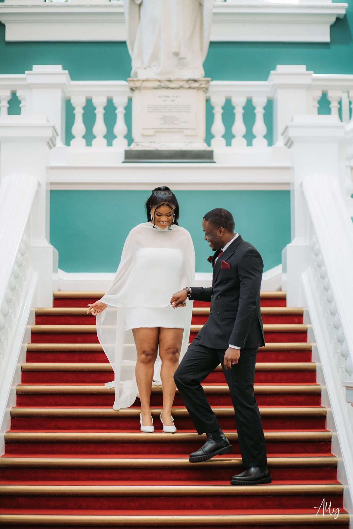 Mercy and Ifeoluwa together on the red-carpeted staircase